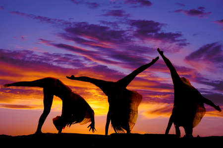 A silhouette of a woman doing a cartwheel.の写真素材