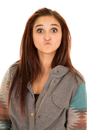A woman with her lips puckered, wearing a jacket.の写真素材