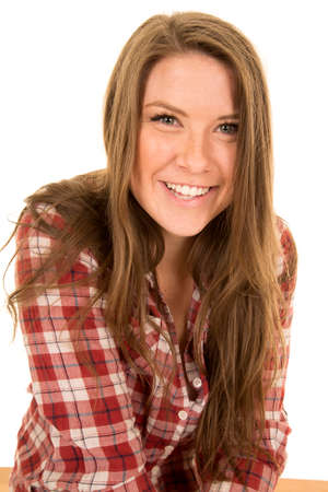 A woman in her plaid shirt with a smile on her face.の写真素材