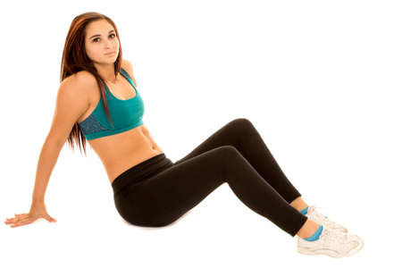 A woman in her fitness clothing sitting stretching.の写真素材