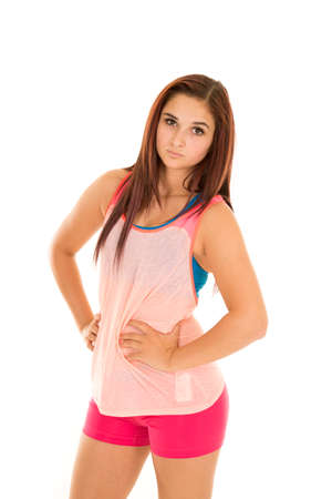 A woman in her pink tank and spankies with her hands on her hips.の写真素材