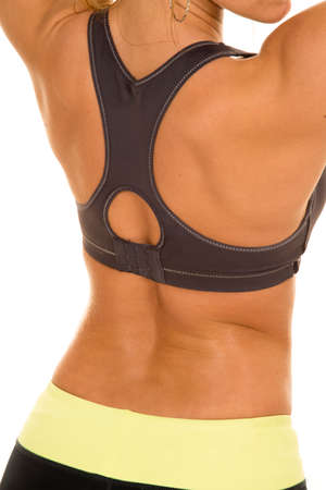 A woman's back with a black sports bra close up.の写真素材
