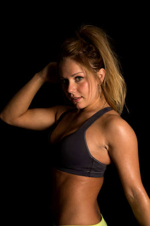 A woman in her fitness clothing, sweating with and intense expression.の写真素材