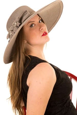 A woman with a serious expression on her face, looking over her shoulder.の写真素材