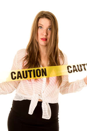 A wom with a funny expession on her face with caution tape across her chest.の写真素材