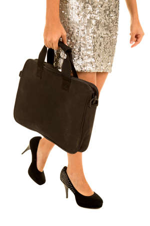 A close up of a woman's legs walking with a briefcase.の写真素材