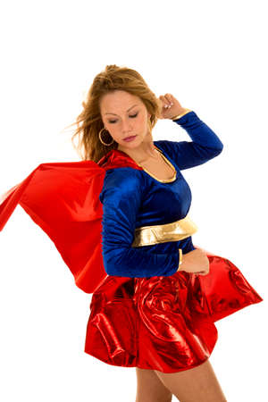 a super woman with the wind blowing her cape and hair.の写真素材