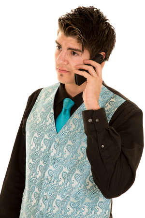 A man in his business vest talking on his cell phone.の写真素材