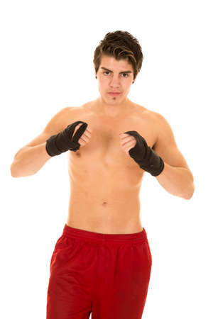 a man in his red shorts wearing his kick boxing wraps.の写真素材