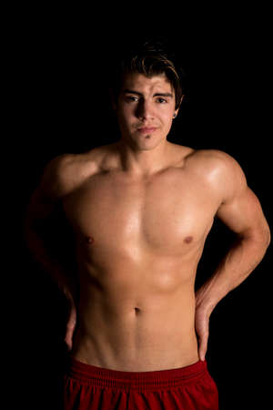 A man in his fitness clothing flexing his arms.の写真素材