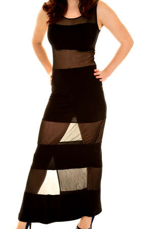 A woman in her black and sheer dress with her hands on her hips.の写真素材