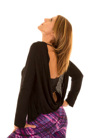 A woman standing looking up with her back showing.の写真素材