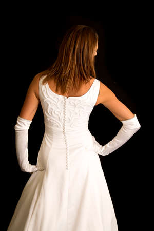 A woman with her back to the camera while wearing her wedding dress.の写真素材