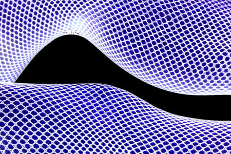 A close up of a womans legs in blue and white with fishnets stockings.の写真素材
