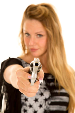 A close up of a woman holding onto a gun, pointing it at the camera.の写真素材