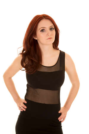 a woman with a serious expression on her face, wearing her black formal dress.の写真素材