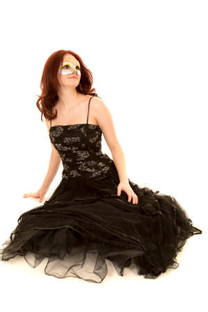 A woman sitting in her formal dress wearing her mask.の写真素材
