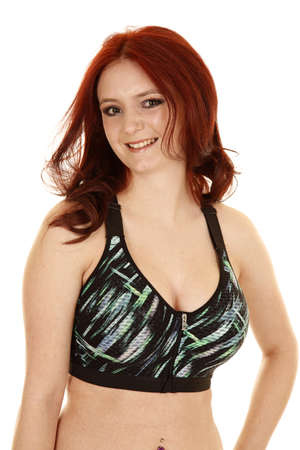 A woman in her fitness top with a smile on her face.の写真素材