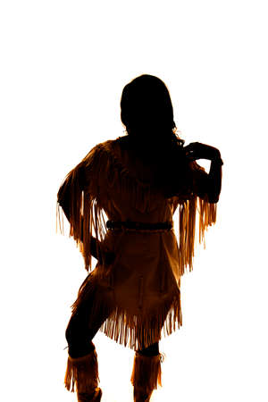 a silhouette of a Native American woman in her tradtional clothing.の写真素材