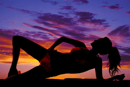 A silhouette of a woman in her bikini outdoors side.の写真素材