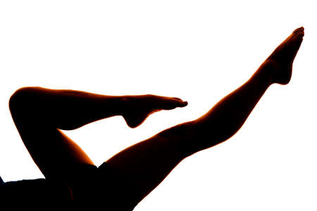 A silhouette of a woman's legs pointing out.の写真素材