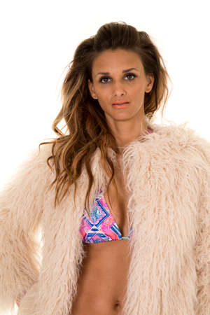 a woman in her bikini with a sensual expression on her face, wearing her fur coat.の写真素材