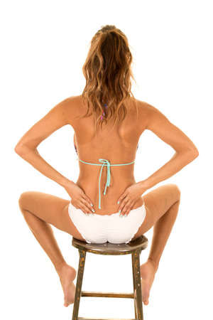 a woman in her bikini with just her back facing the camera.の写真素材