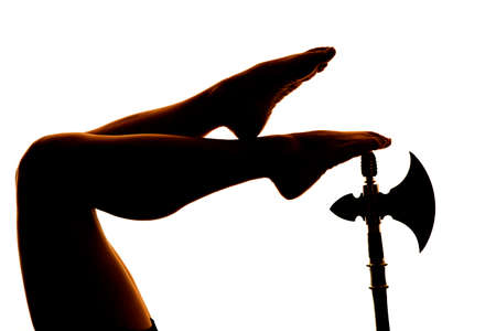 a silhouette of a woman's legs on a hatchet.の写真素材