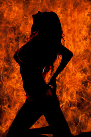 A silhouette of a woman in her bikini with a flame background.の写真素材
