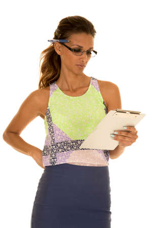 a woman taking notes with a serious expression on her face.の写真素材