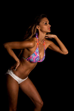 a woman in her bikini leaning forward with a sensual expression.の写真素材