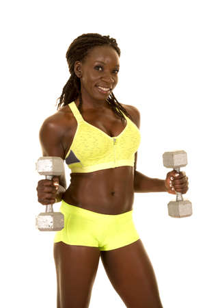 A woman in her fitness clothing working out with weights.の写真素材