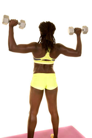 An African American working out her shoulders with weights.の写真素材