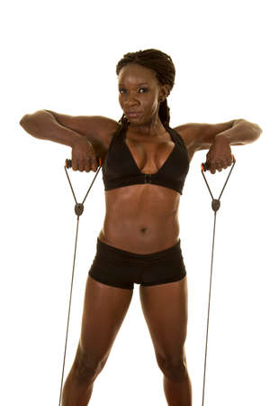 An African American woman using her exercise bands to work out.の写真素材
