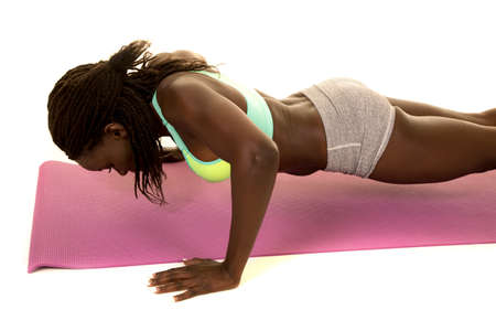An African American woman doing a push up.の写真素材