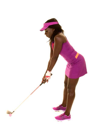 an African American in her golf clothing, with a club and ball.の写真素材