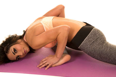 a woman stretching out with her head down.の写真素材