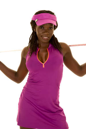 An African American woman in her golf clothes holding her club.の写真素材