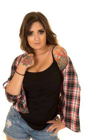 A woman in her plaid top falling off of her shoulder, with her tattoo showing.の写真素材
