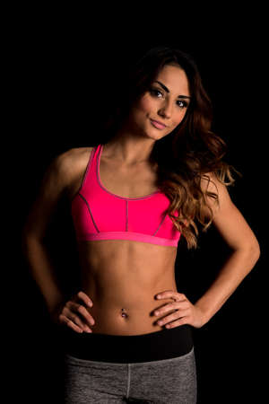 A woman in her fitness clothing, with her hands on her hips.の写真素材