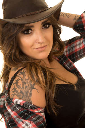 A cowgirl up close with her tattoo on her shoulder showing.の写真素材