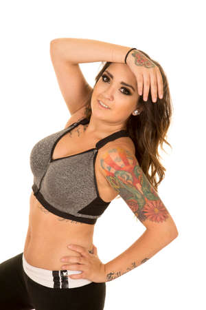 A woman in her fitness clothing, and her tattoos showing.の写真素材