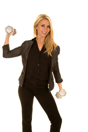 A blond woman in her business clothing working out with fitness weights.の写真素材