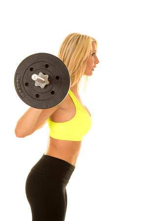 a woman in her fitness clothing doing a weighted squat.の写真素材