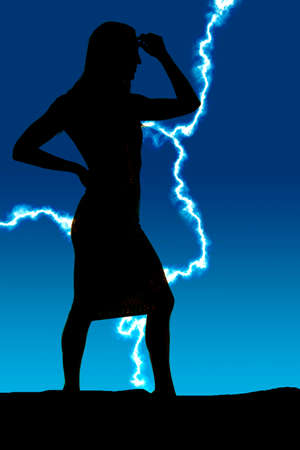 a silhouette of a woman with her hand on her head in thought.の写真素材
