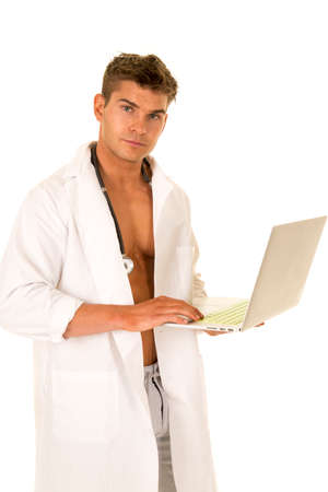 A Doctor looking to the side, holding on to his laptop working.の写真素材