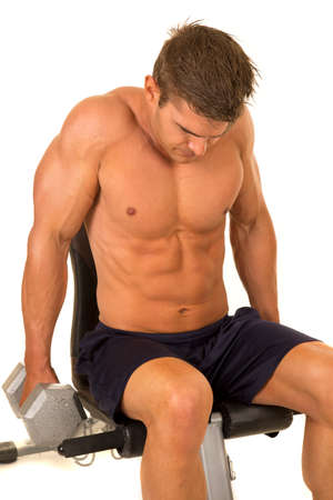 a shirtless man working out with his weights, doing a shrug.の写真素材