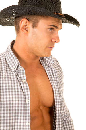A close up of a cowboy with his shirt undone, showing off his muscular chest.の写真素材