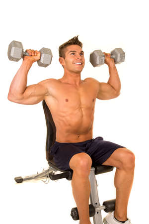 A man doing a shoulder press with weights.の写真素材