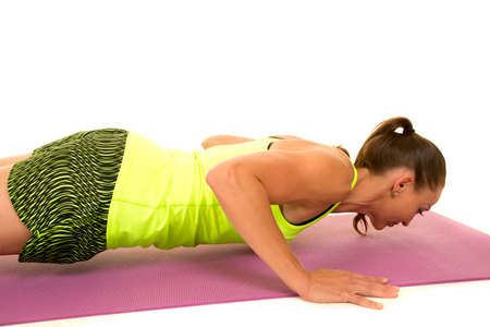 A woman doing a push up, going low.の写真素材